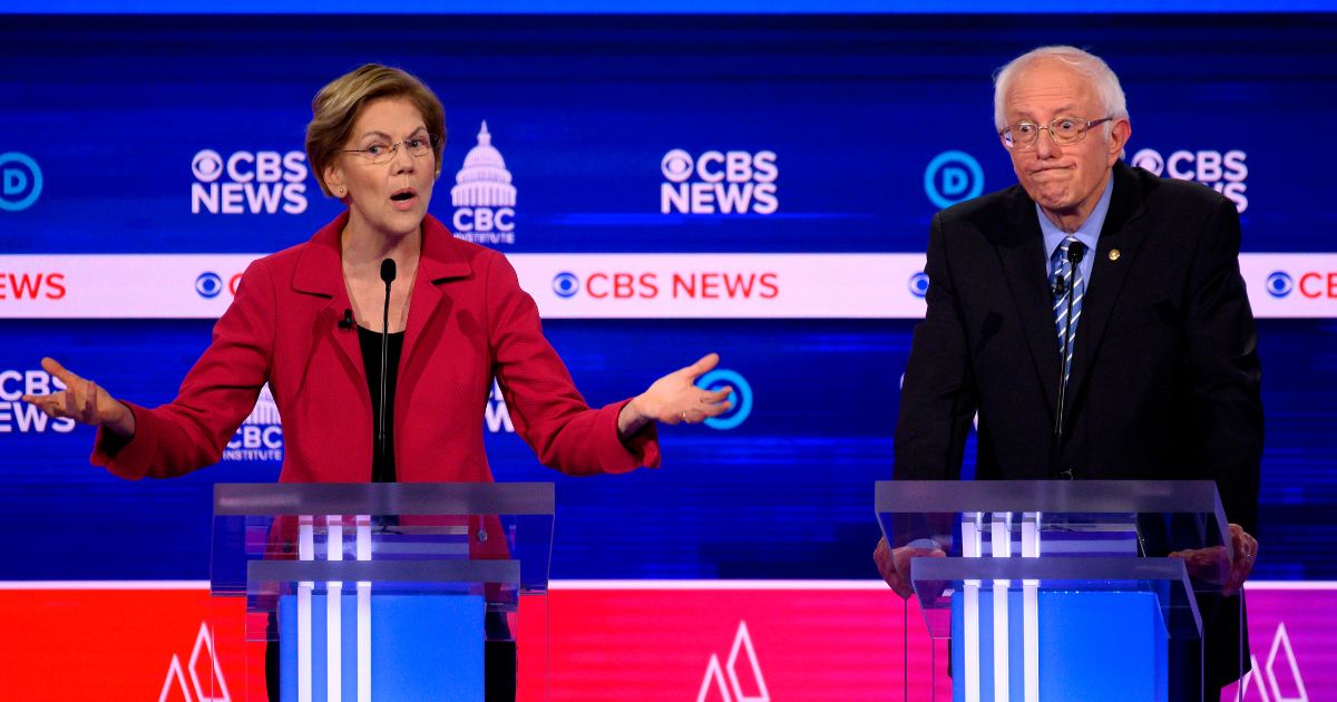 Massachusetts Sen. Elizabeth Warren and Vermont Sen. Bernie Sanders are pictured in a file photo from a Democratic presidential primary debate in February 2020.