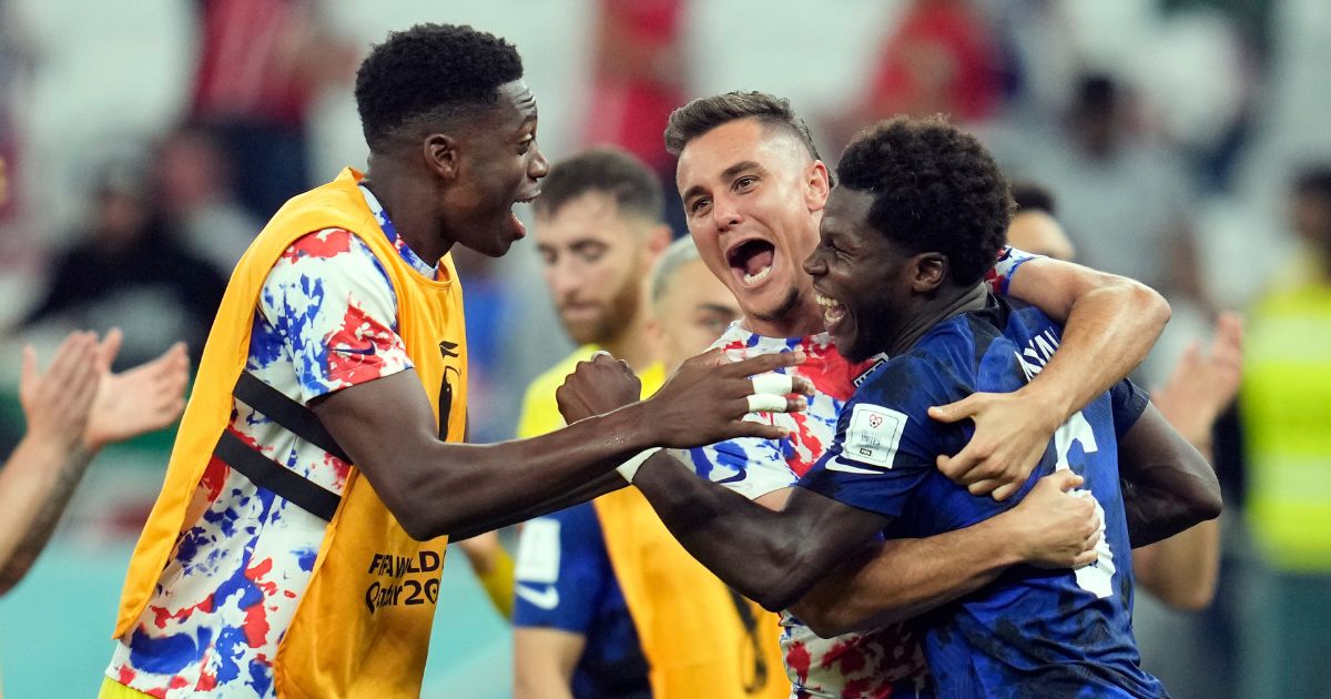 United States' Yunus Musah (R), Aaron Long (C), and United States' goalkeeper Sean Johnson celebrate after defeating Iran in the World Cup group B soccer match at the Al Thumama Stadium in Doha, Qatar, on Tuesday.