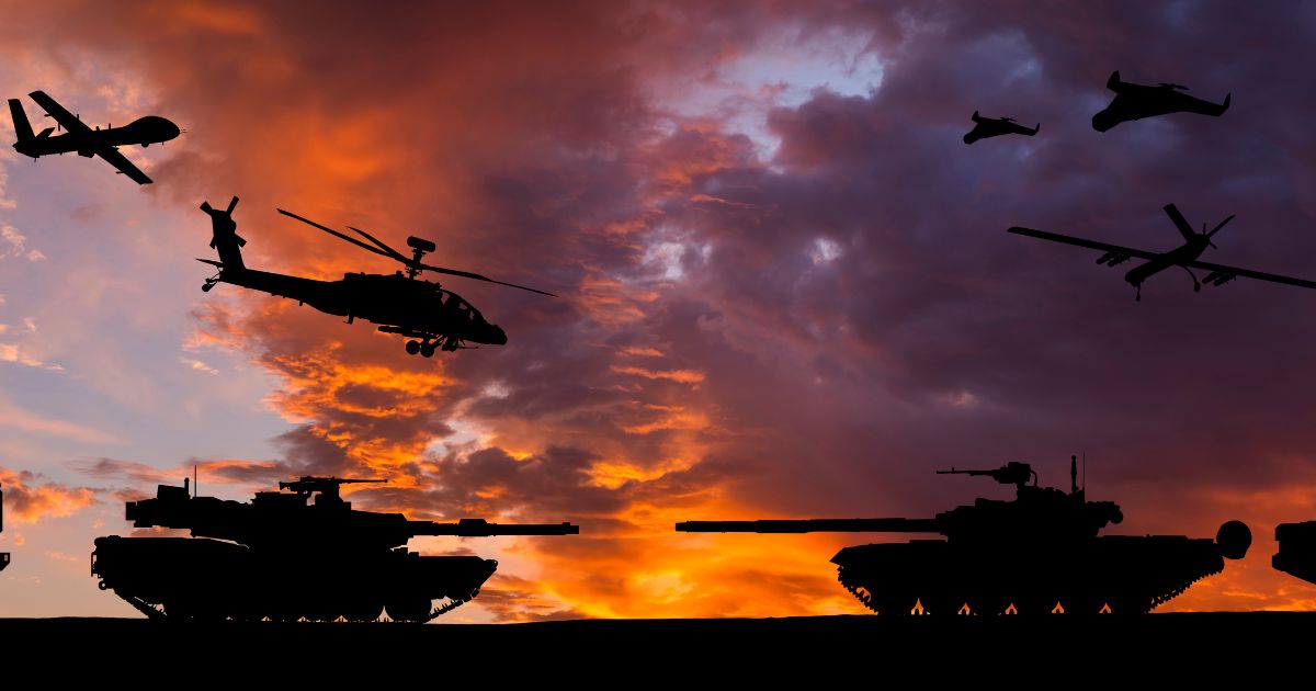 Armored tanks, combat drones and missile launchers are pictured at sunset.
