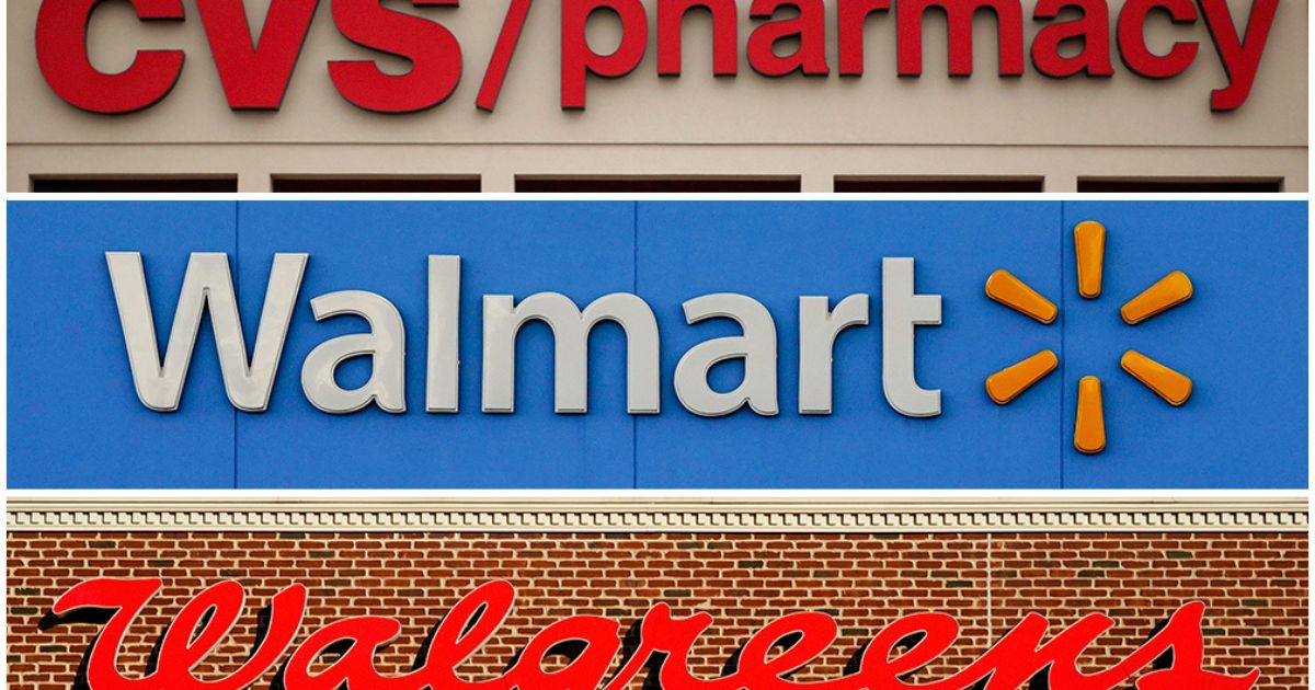 This undated combination of file photos show the signs of CVS, Walmart and Walgreens.