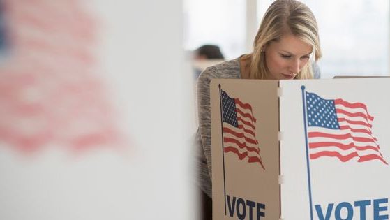 This stock photo shows a woman voting on Election Day.