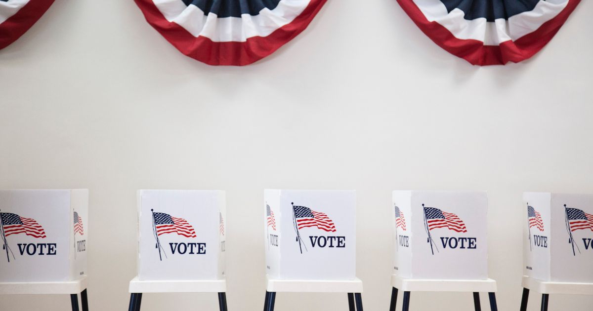 This stock photo pictures voting booths in a polling location.