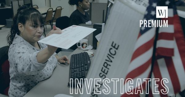 Early ballot processing clerk, Regina Rivera, reaches for an affidavit containing an early ballot that will be scanned for signature verification before being tabulated at the Maricopa County Tabulation and Election Center in Phoenix, Arizona.