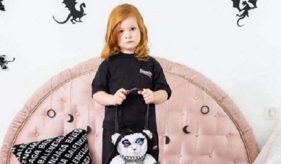 An advertistising campaign for the Balenciaga fashion house included an image that showed what appears to be a young girl holding a teddy bear that is clad in bondage gear.