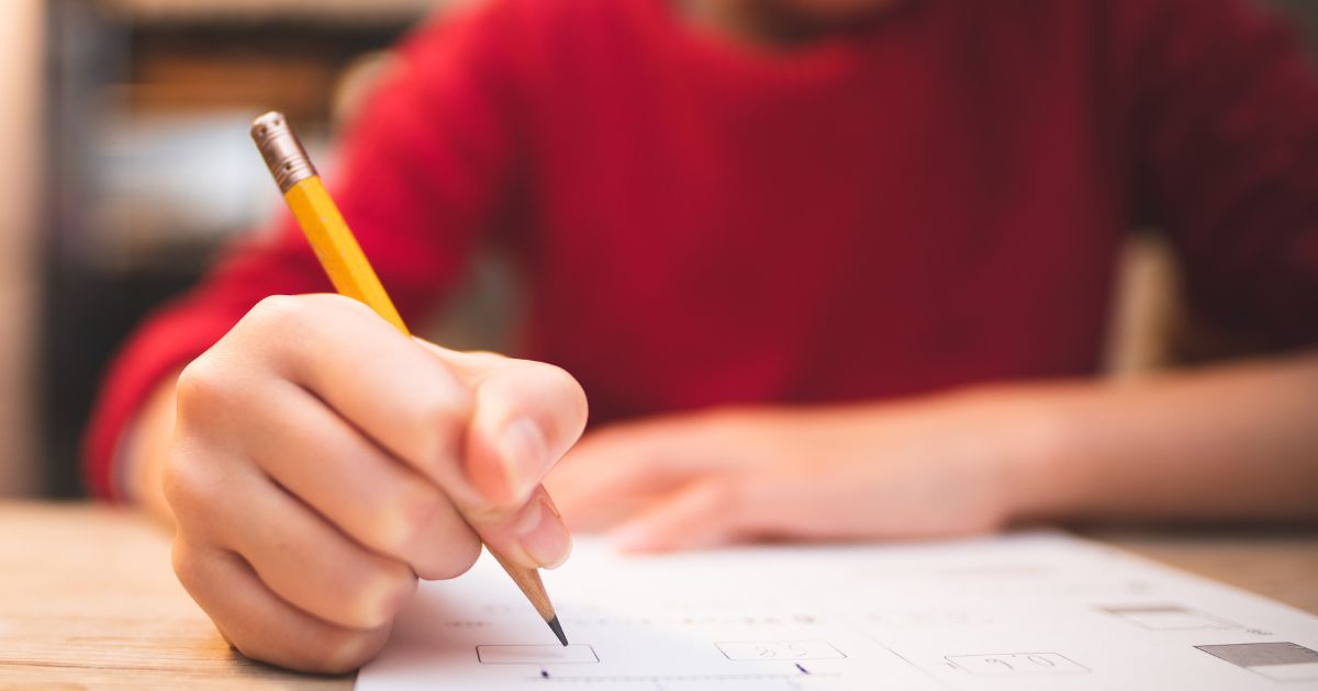 A child studies in this stock image.