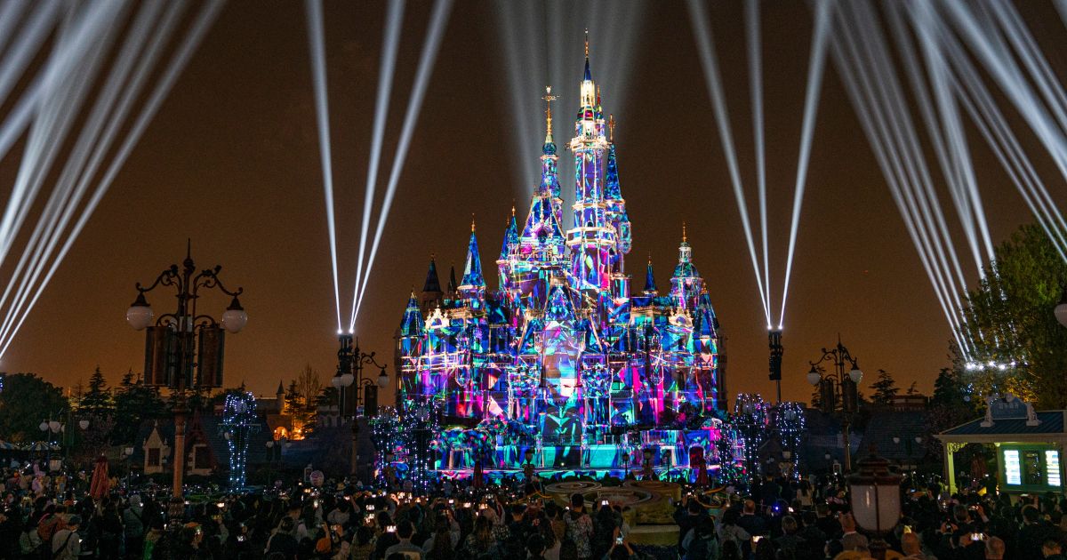 Tourists gather in front of the Disney castle for the nighttime show on April 8, 2021, in Shanghai, China.