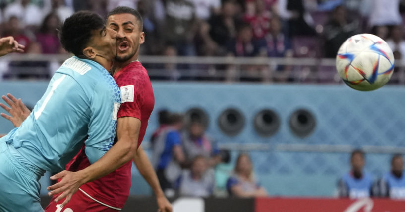 Iran's goalkeeper Alireza Beiranvand collides with teammate Majid Housseini during the World Cup game between Iran and England in Doha, Qatar, on Monday.