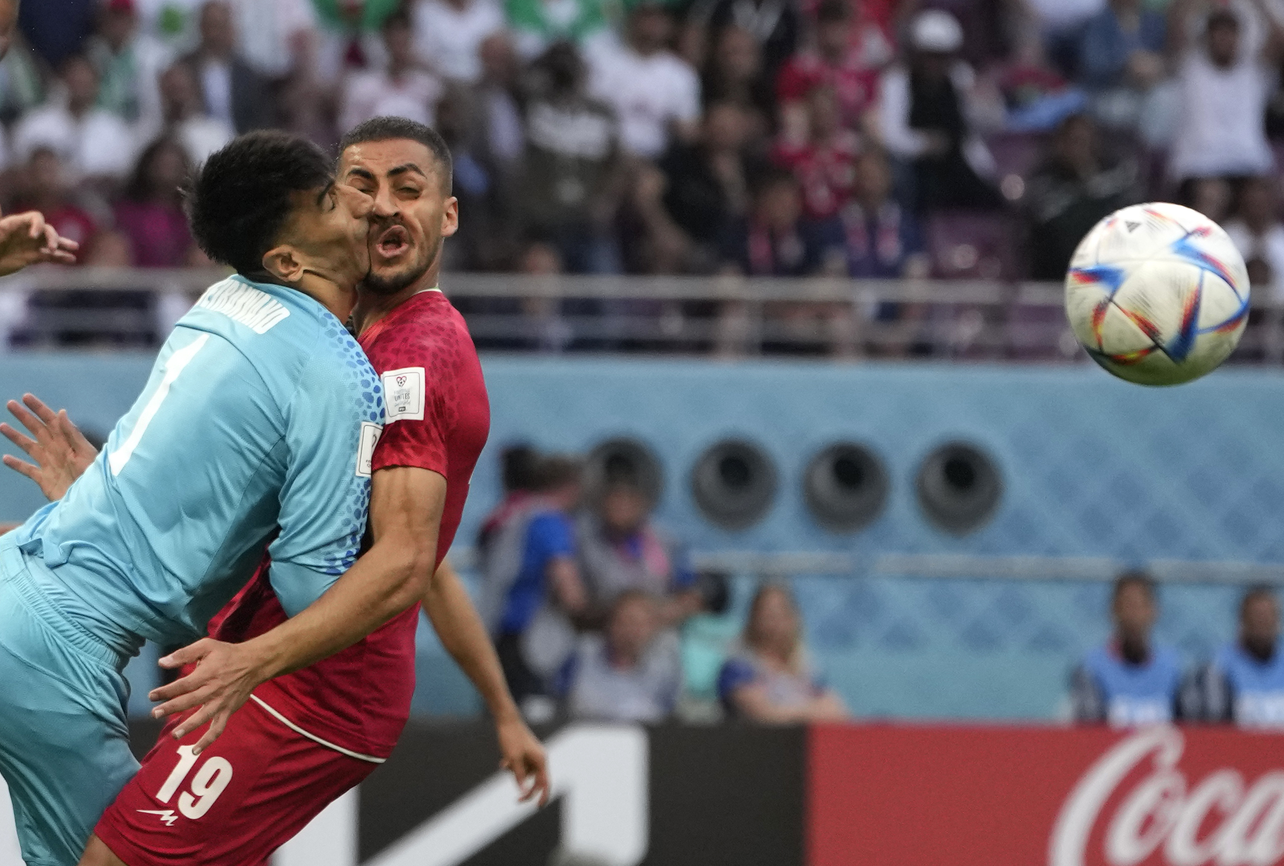 Iran's goalkeeper Alireza Beiranvand collides with teammate Majid Housseini during the World Cup game between Iran and England in Doha, Qatar, on Monday.