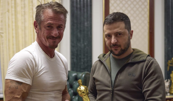 In this photo provided by the Ukrainian Press Office, Ukrainian President Volodymyr Zelesky, right, poses with U.S. actor Sean Penn, left, after receiving the latter's Oscar statuette and handing him the Order of Merit, III degree during a meeting in Kyiv, Ukraine, on Tuesday.