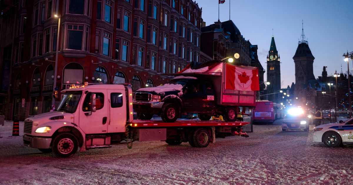 A flatbed removes a truck from the 'Freedom Convoy' in Ottawa, on February 19, 2022.