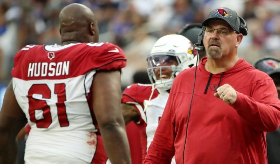 Offensive line coach Sean Kugler of the Arizona Cardinals fist bumps Rodney Hudson after a play during the fourth quarter against the Los Angeles Rams at SoFi Stadium on Oct. 3, 2021, in Inglewood, California.