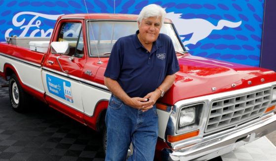 Comedian Jay Leno poses in front of a 1979 Ford F-150 pickup, in the style of one owned by Walmart founder Sam Walton, on Aug. 20 during the 27th annual Woodward Dream Cruise, in Royal Oak, Michigan.