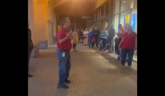 A Maricopa County, Arizona, election worker explains to voters in line that the polling site is having tabulation problems.