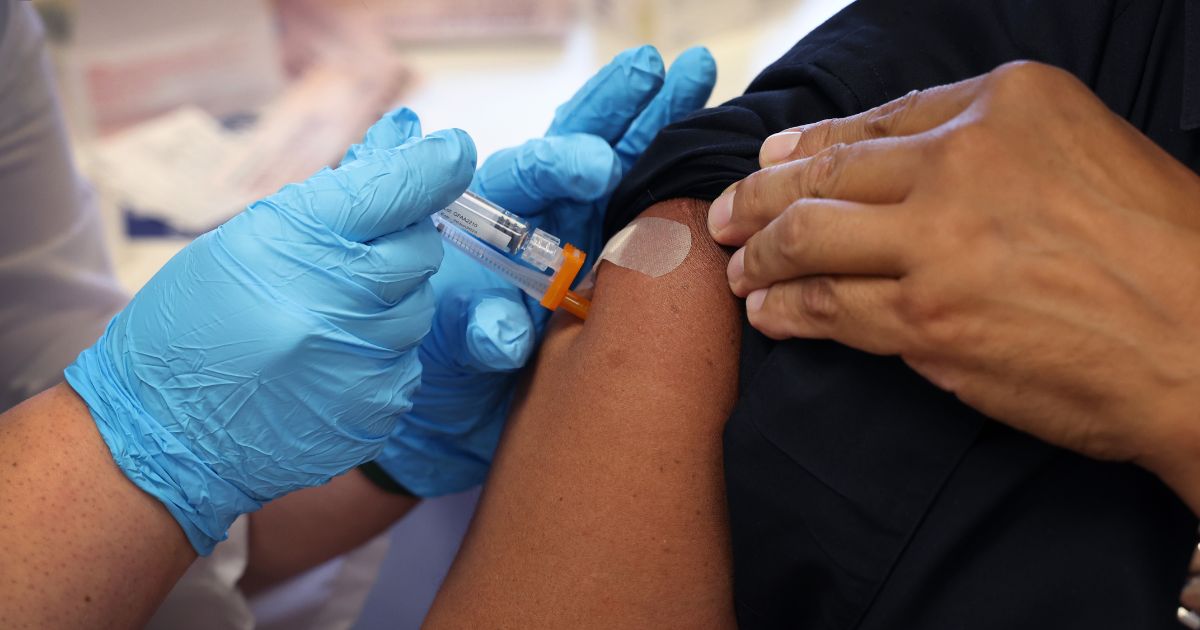 A person receives a pneumonia vaccine on Sept. 9 in Chicago.