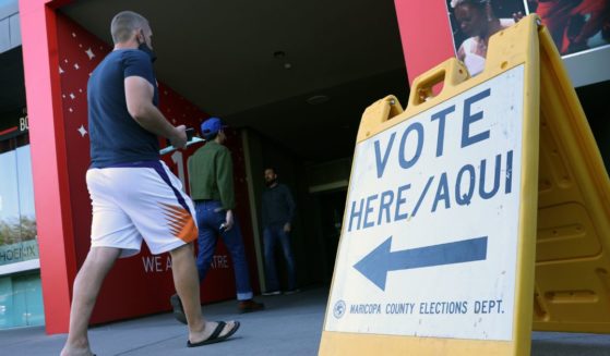 Voters arrive to cast their ballots at the Phoenix Art Museum on Tuesday in Phoenix.
