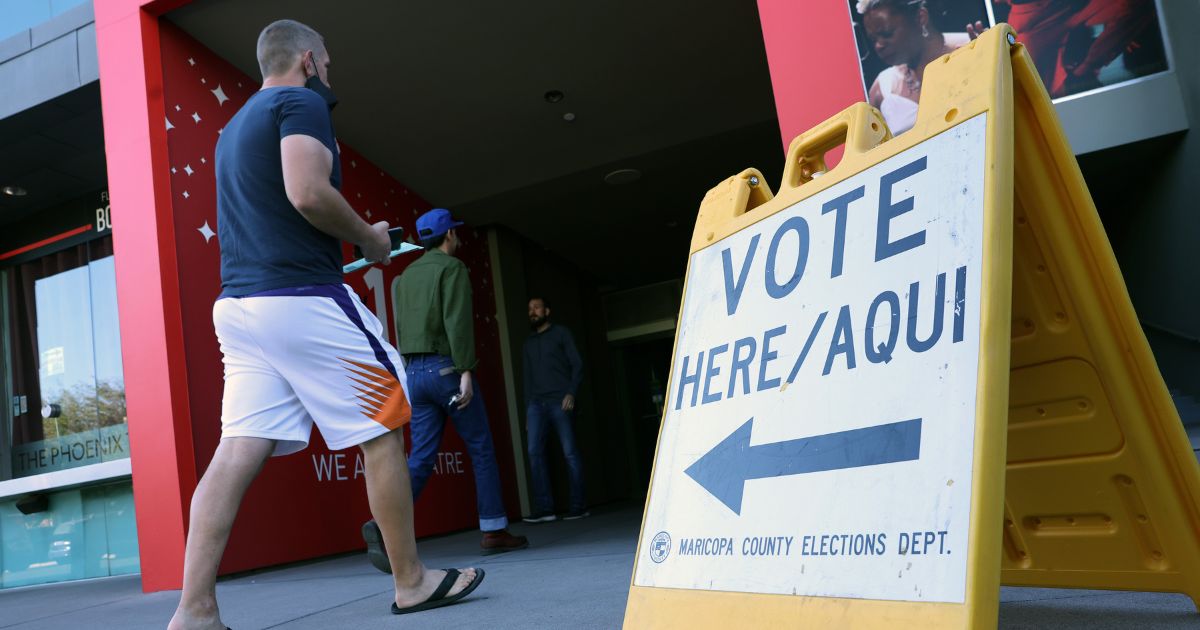 Voters arrive to cast their ballots at the Phoenix Art Museum on Tuesday in Phoenix.