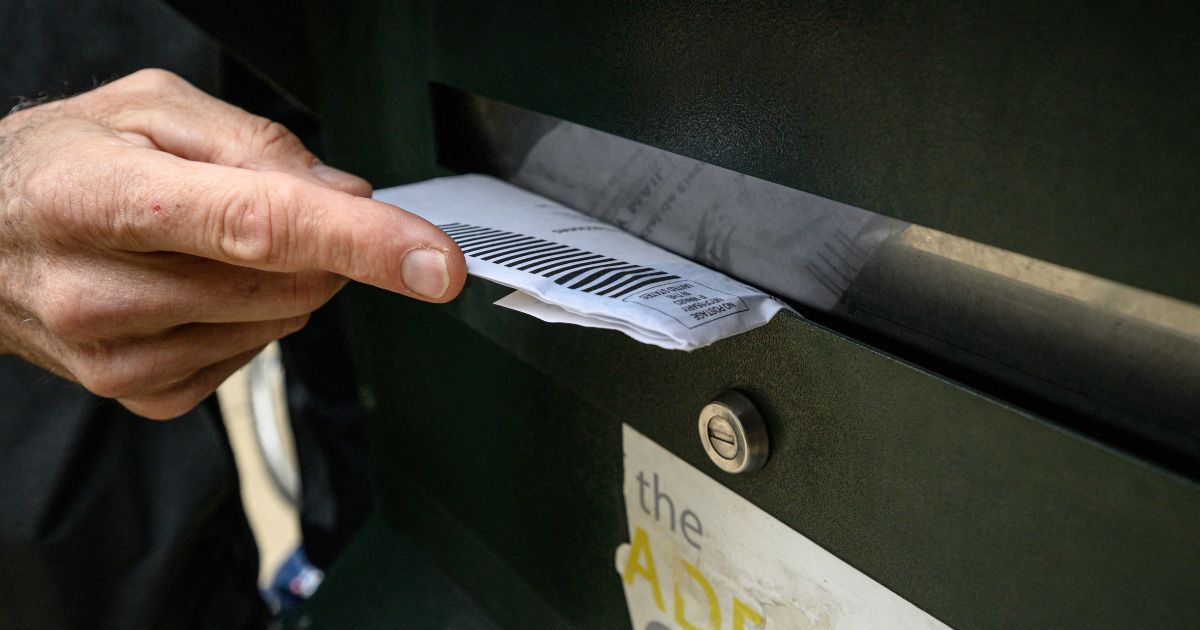 A voter casts their ballot at a drop box is displayed outside Philadelphia city hall on Oct. 24.