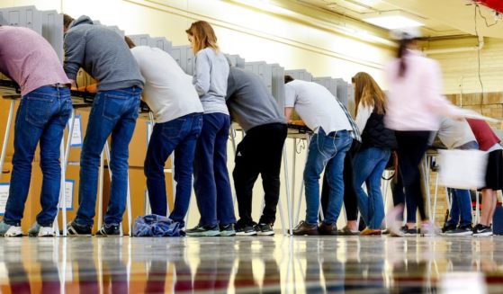 People vote at Denver East High School on Tuesday in Denver.