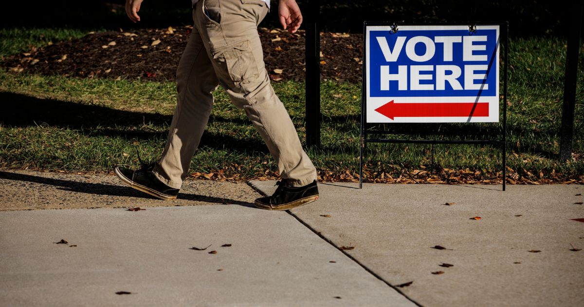 A man walks toward an early voting location on Thursday in Stafford, Virginia.