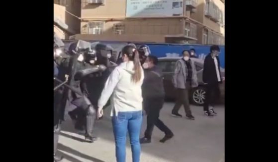 A lone woman stood against a line of Chinese riot police.