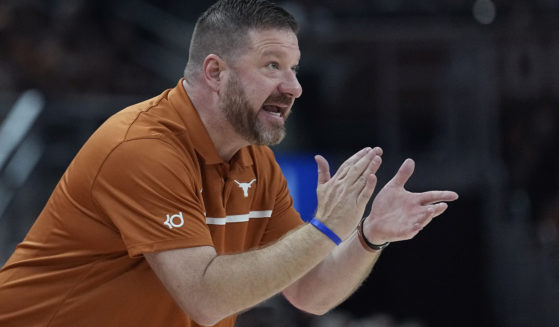Texas head coach Chris Beard talks to his players during the first half of an NCAA college basketball game against Arkansas-Pine Bluff in Austin, Texas, on Saturday.