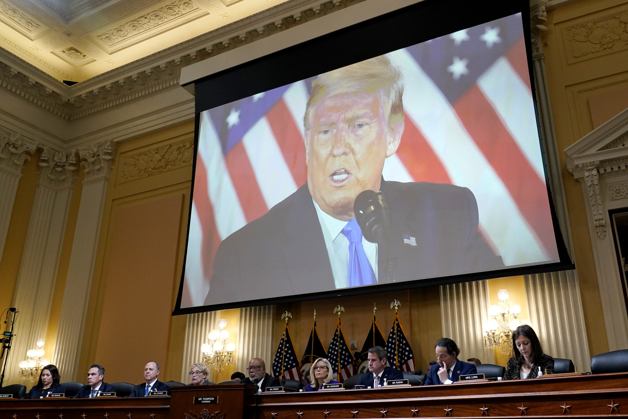 A video of former President Donald Trump is shown on a screen, as the House Jan. 6 committee holds its final meeting on Capitol Hill on Dec. 19.