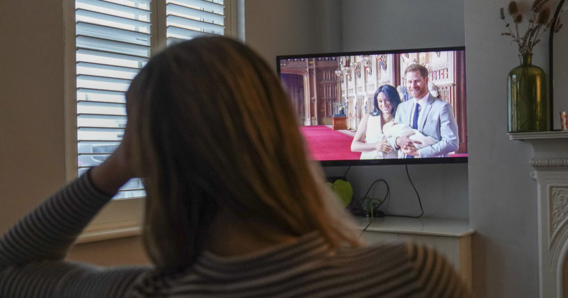 A woman named Georgia watches the Duke and Duchess of Sussex's controversial documentay being aired on Netflix at her home in Warwick, Britain, on Thursday.