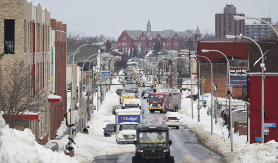 Main St. in Buffalo, New York, has some people and vehicles moving across it on Monday after a massive snow storm hit the city.