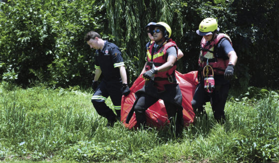 Rescuers carry the body of a flood victim that was retrieved from the Jukskei river in Johannesburg, South Africa, on Sunday.