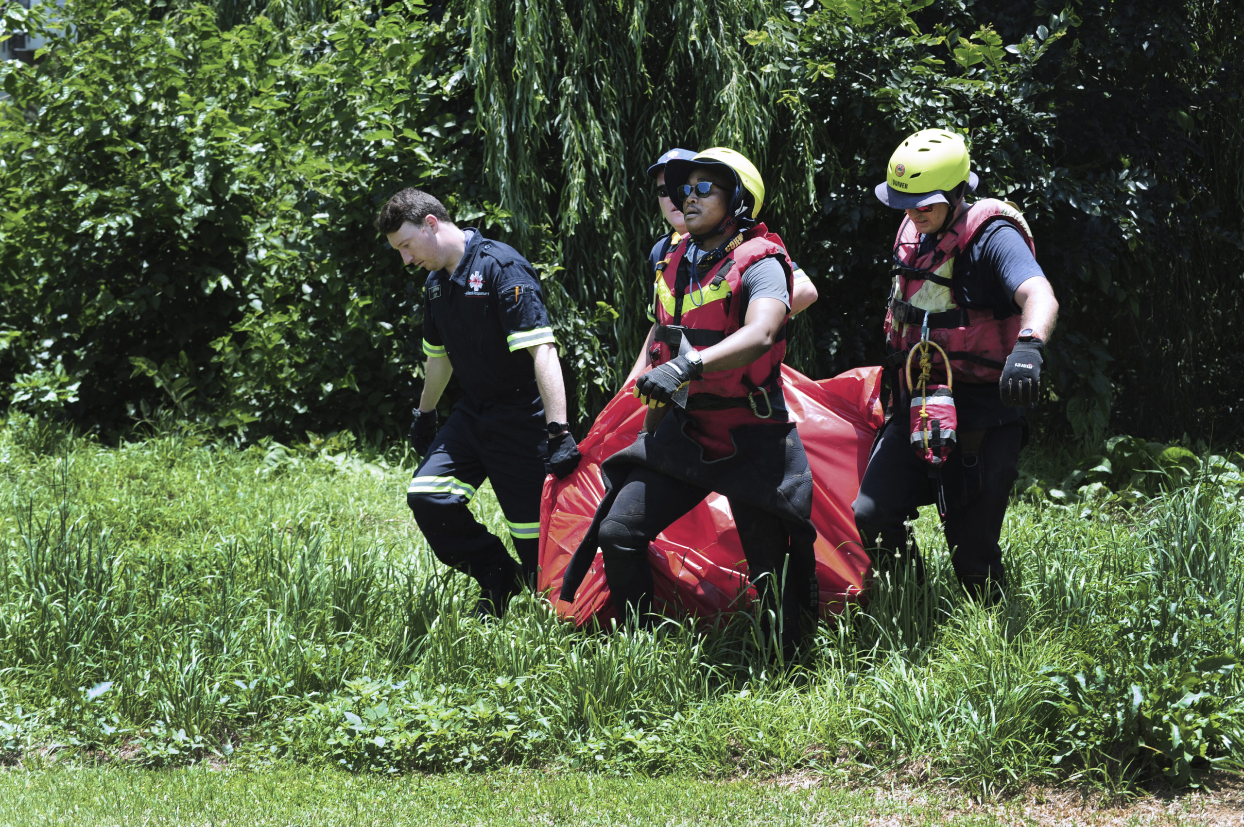 Rescuers carry the body of a flood victim that was retrieved from the Jukskei river in Johannesburg, South Africa, on Sunday.