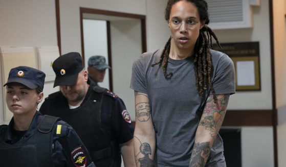 WNBA star and two-time Olympic gold medalist Brittney Griner is seen in an August file photo being escorted from a courtroom near Moscow. Russia freed Griner on Thursday in a dramatic high-level prisoner exchange, with the U.S. releasing notorious Russian arms dealer Viktor Bout.