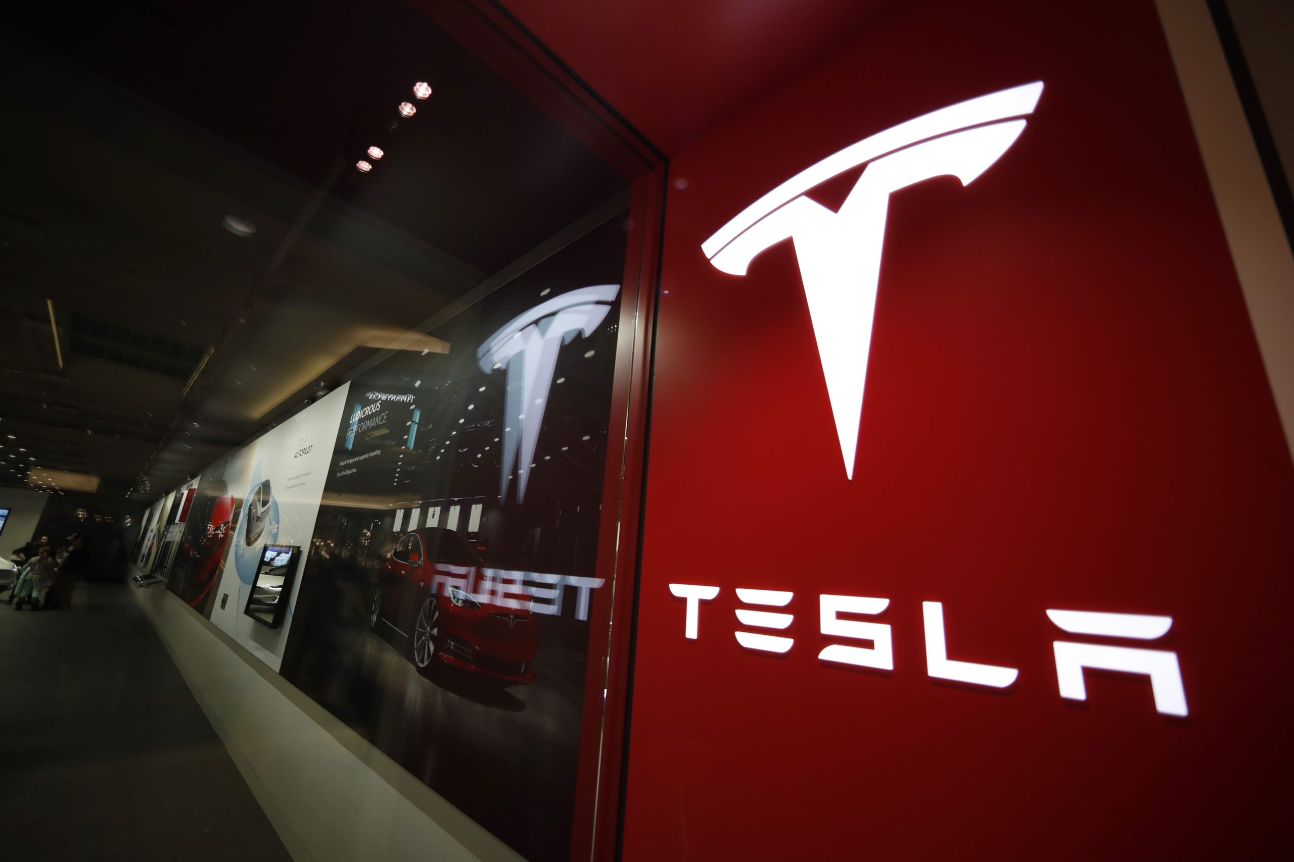 A sign bearing the company logo outside a Tesla store in Cherry Creek Mall in Denver, Colorado, is pictured on Feb. 9, 2019.