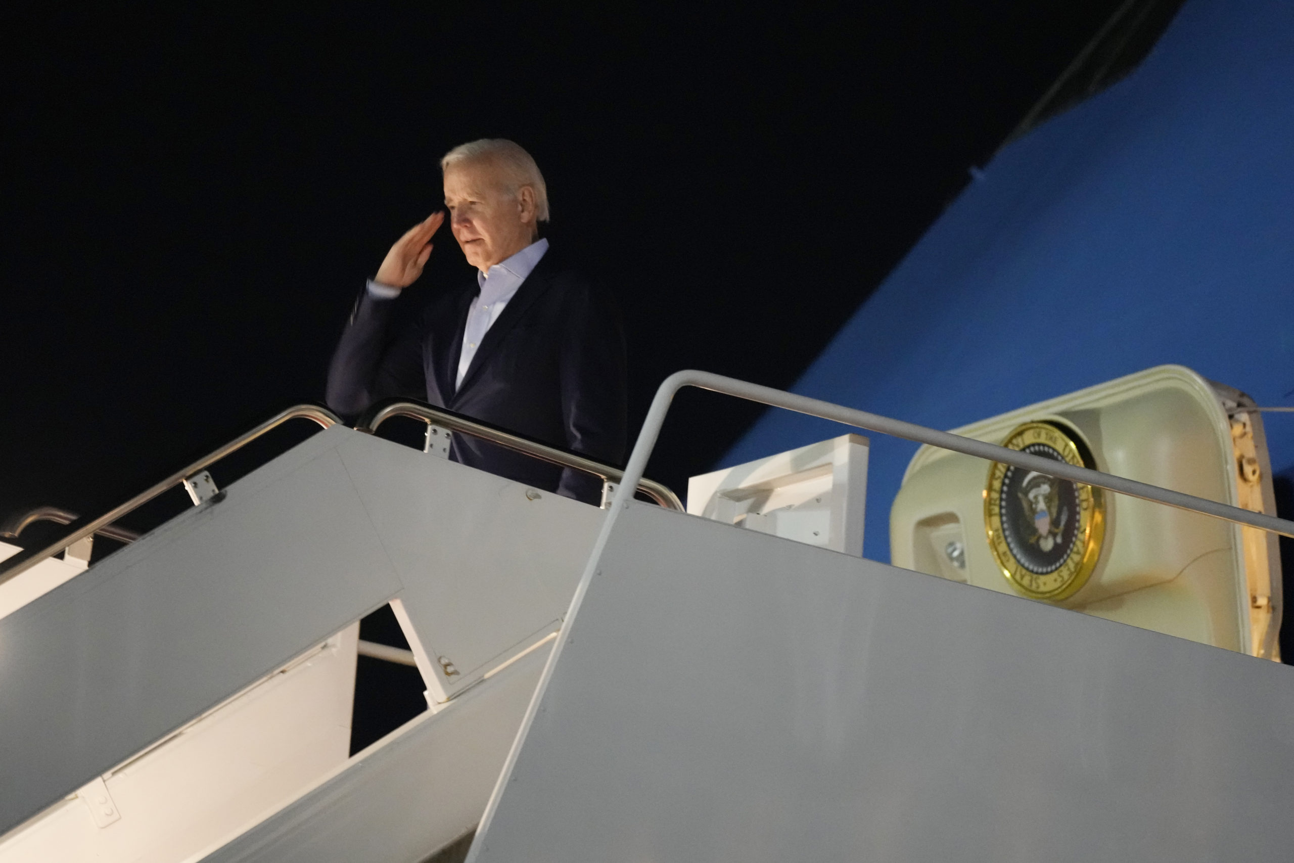 President Joe Biden salutes as he boards Air Force One at Andrews Air Force Base, Maryland, Tuesday. Biden and his family were traveling to St. Croix, U.S. Virgin Islands, to celebrate New Year.