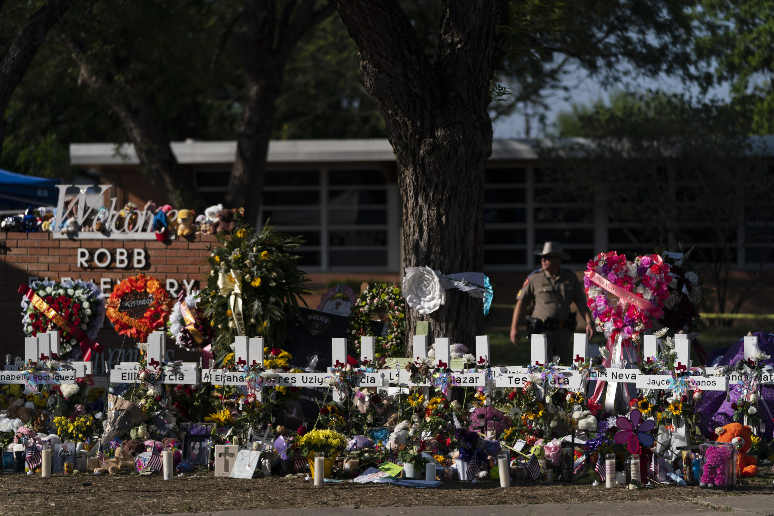 Flowers and candles are placed around crosses on May 28 at a memorial outside of Robb Elementary School in Uvalde, Texas.