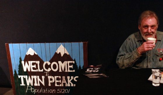Actor Al Strobel who played on the TV series Twin Peaks the character Mike the 'one-armed man' drinks a cup of coffee while signing autographs for fans during the sixth annual Twin Peaks UK Festival at Genesis Cinema on October 3, 2015 in London.