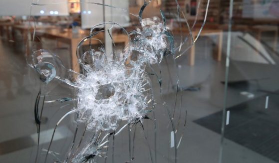 A broken storefront window in Chicago is seen in a file photo from August of 2020.