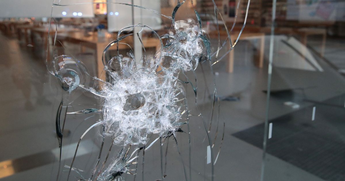 A broken storefront window in Chicago is seen in a file photo from August of 2020.
