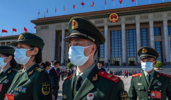 Military delegates leave after the opening of the national congress of the Communist Party of China on Oct. 16 in Beijing.
