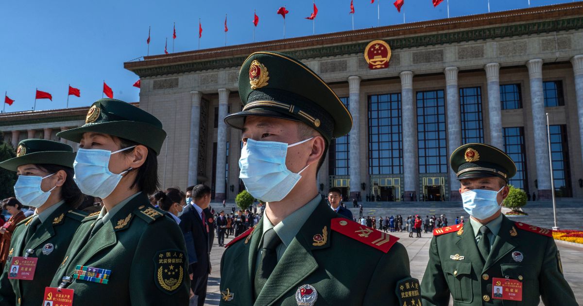 Military delegates leave after the opening of the national congress of the Communist Party of China on Oct. 16 in Beijing.
