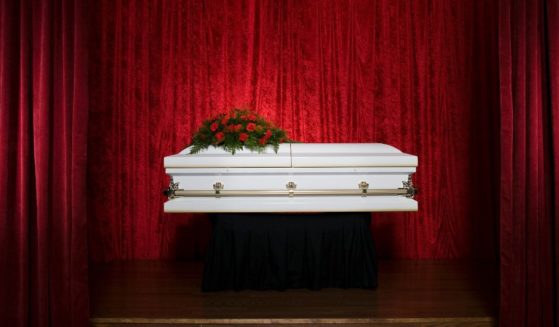 A coffin is on a stage in this stock photo.