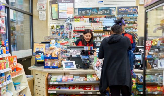 A customer makes a purchase at a 7-Eleven store in New York in March 2016.