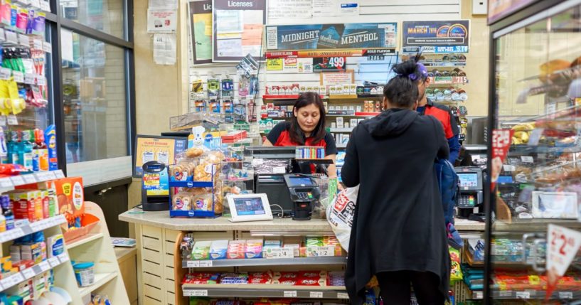 A customer makes a purchase at a 7-Eleven store in New York in March 2016.
