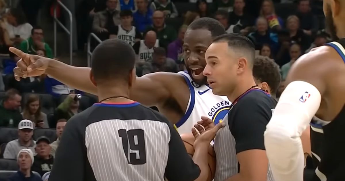 Draymond Green of the Golden State Warriors complains to officials about a fan.