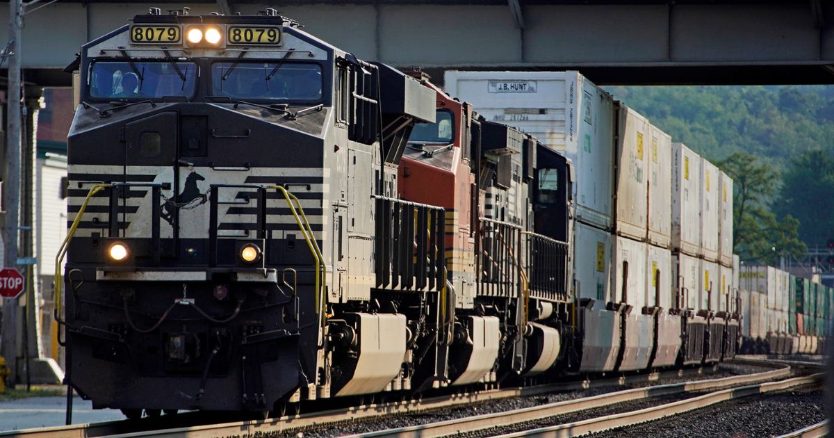 A freight train runs through a crossing in Homestead, Pennsylvania, on Sept. 14.