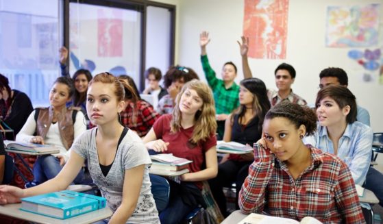 This stock photo shows a classroom full of teenage students during a lesson.