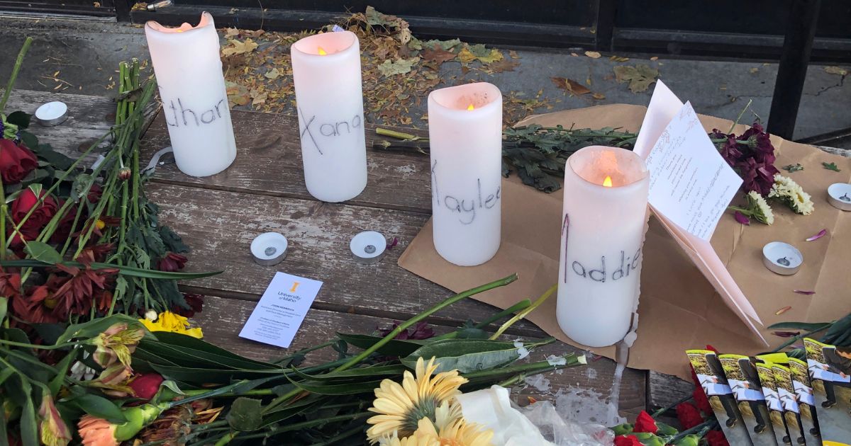 Candles and flowers are left at a make-shift memorial honoring four slain University of Idaho students outside the Mad Greek restaurant in downtown Moscow, Idaho, on Nov. 15.