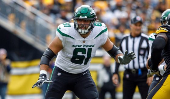Jets offensive tackle Max Mitchell blocking during a game
