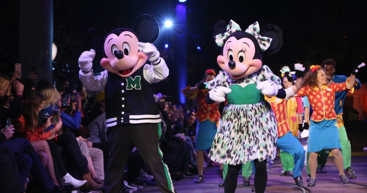 Mickey and Minnie Mouse walking down the runway