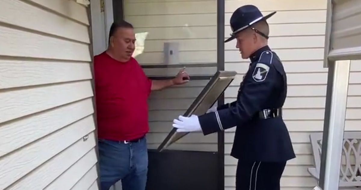 An Idaho State Police Honor Guard member presented the framed photo to the father of fallen Mohave County (Arizona) Deputy Philip Rodriguez.