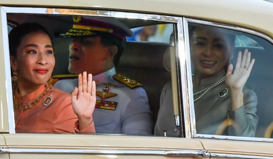 Thailand's Princess Bajrakitiyabha, left, King Maha Vajiralongkorn, center, and Queen Suthida wave to supporters at the Grand Palace in Bangkok in a file photo from November 2020. The princess collapsed Wednesday, reportedly of a heart episode, while training her dogs for a competition.